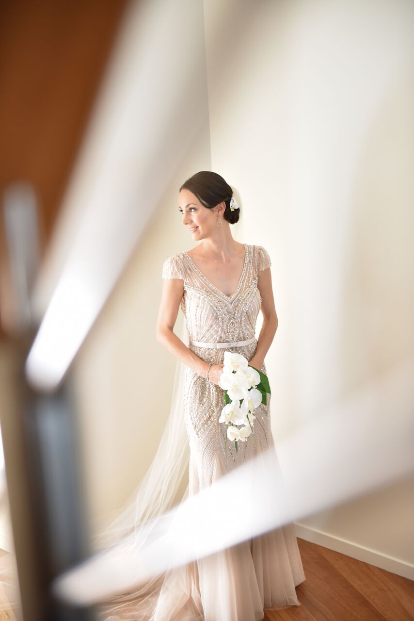 Bride in floral dress against soft light background