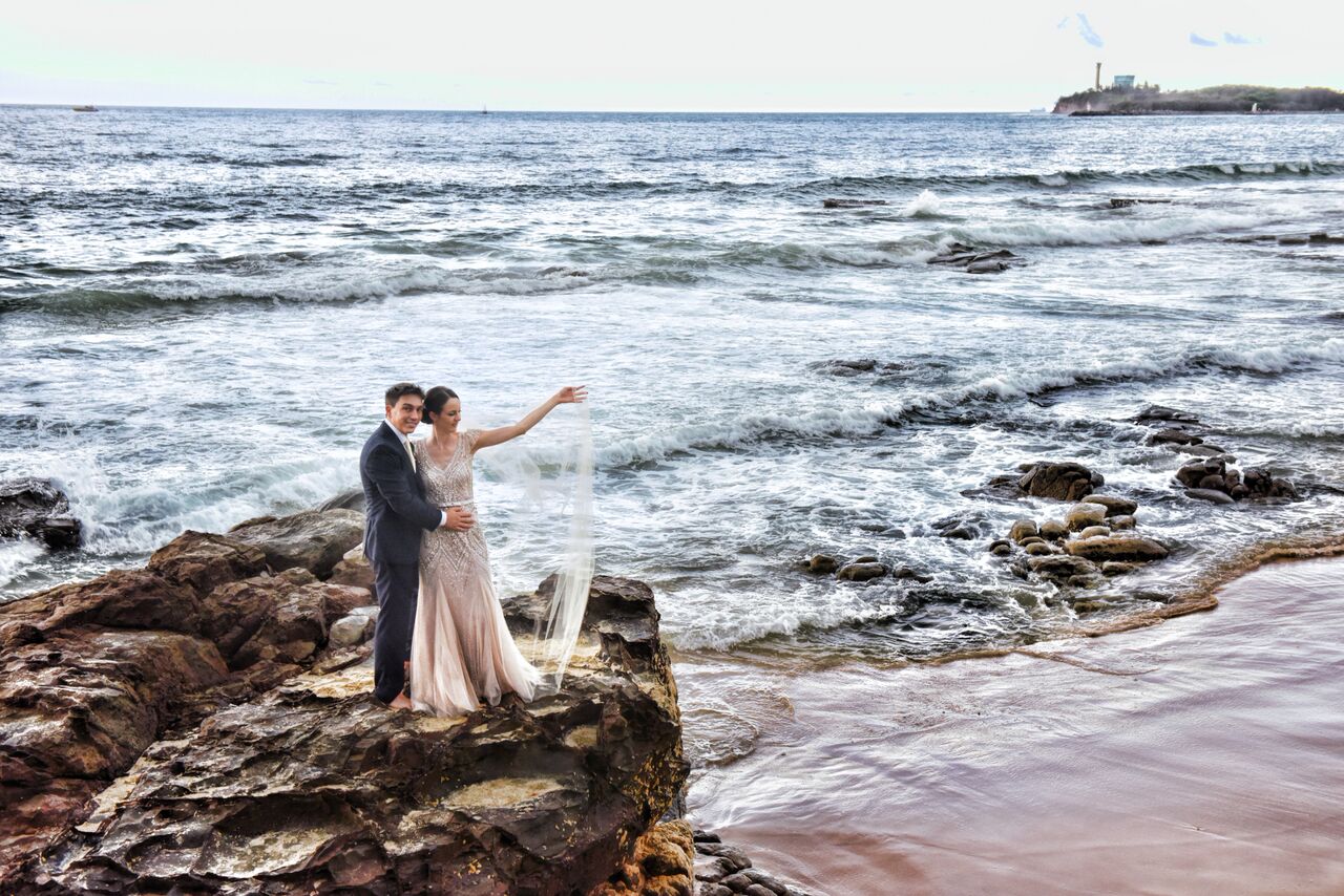 Bride and groom at beach on sunset