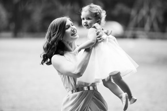 Black and white photo Carla holding her child in the air