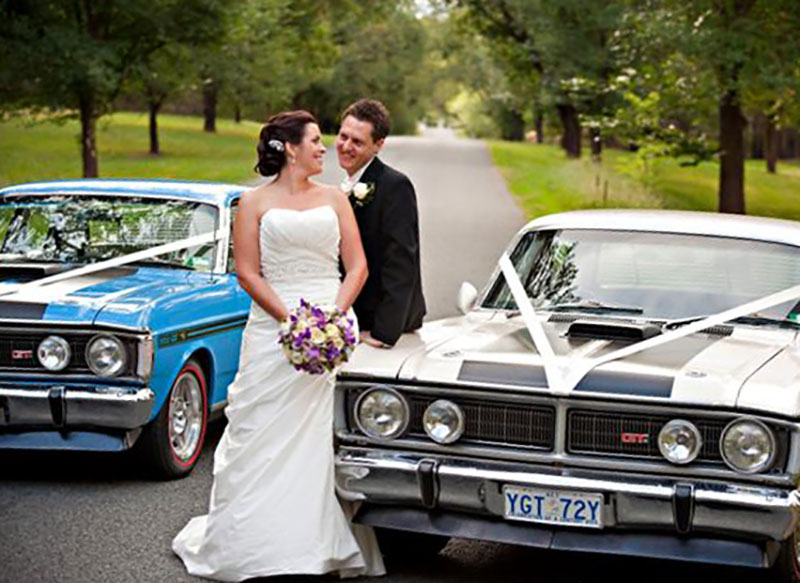 Bride and Groom pose in front of two Falcon GT's.