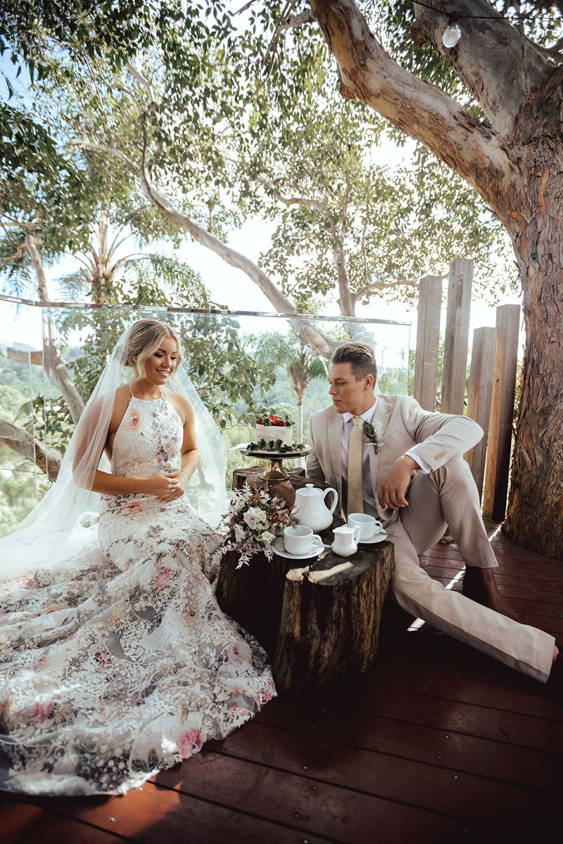 Photo by DK and Co. Photography of Bride and Groom having a tea party in treehouse.