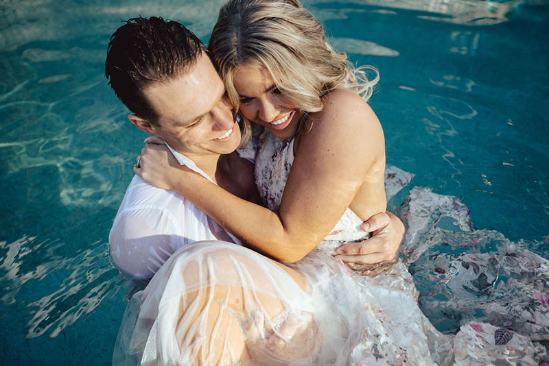 Photo by DK and Co. Photography of Bride and Groom in pool.
