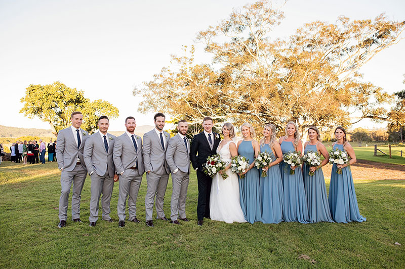 Country themed wedding with the Groomsmen in light grey and Bridesmaids in blue.