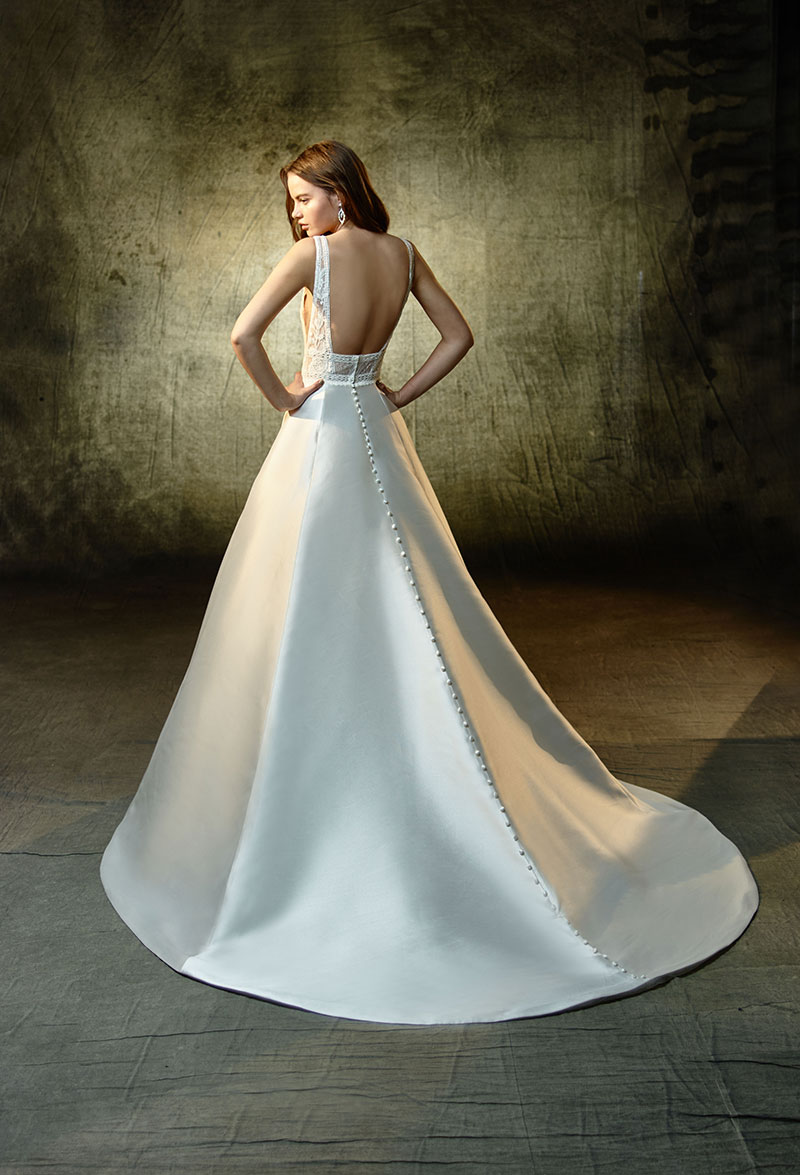 Back view of a gorgeous flowing wedding gown from the Enzoani Collection.