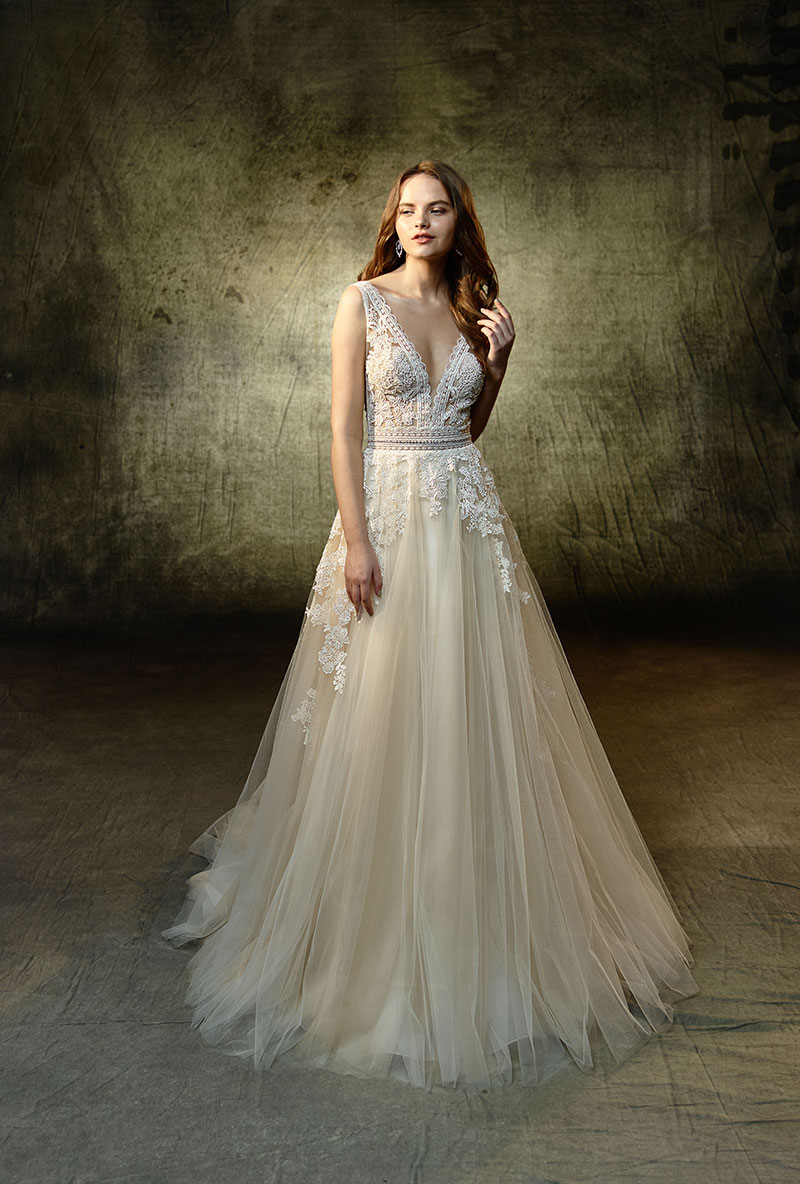 Bride wearing a wedding gown with a lace bodice and soft, flowing skirt from the Enzoani Collection.