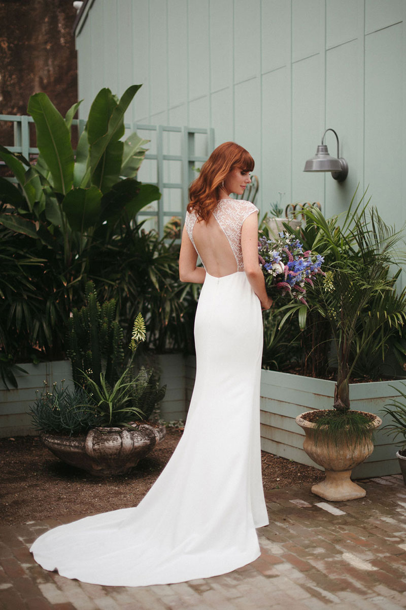 Bride wearing a gown with a cut-out back.