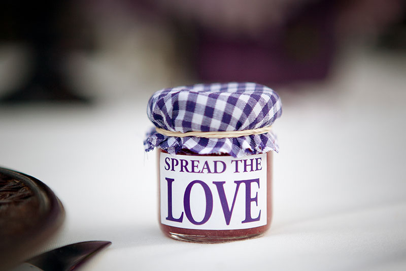 Jar of homemade jam with the message 'spread the love' written on it.