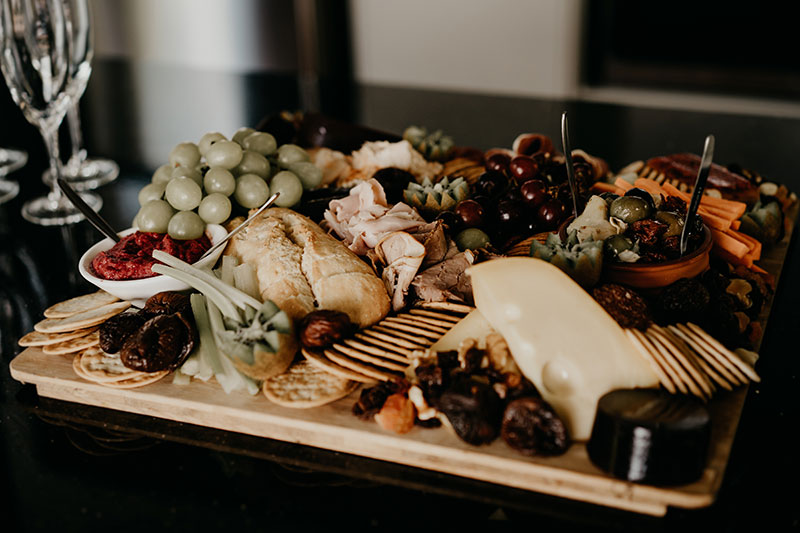 Lots of cheese, olives and dried fruit on this grazing platter.