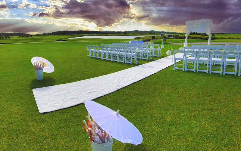 Wedding Ceremony set up with white chairs and white runner at Maroochy River Golf Club.