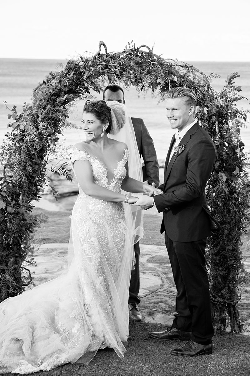 Bride and Groom at a beach wedding looking happy and relaxed during ceremony.