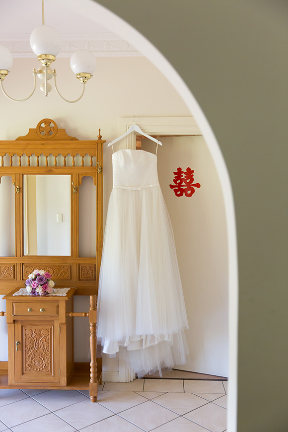 Gorgeous wedding gown from Darb Bridal Couture set on a clother hanger.