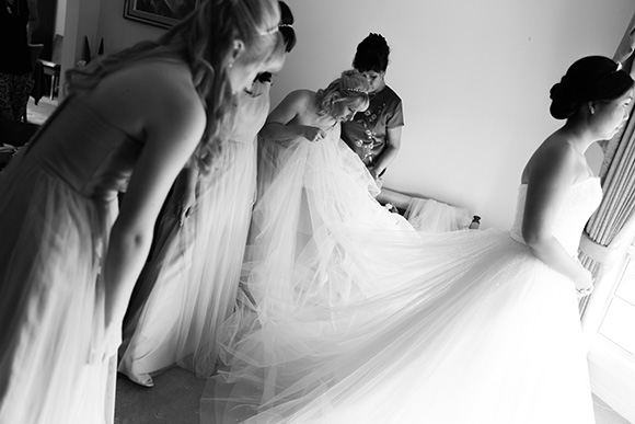 Black and white photo of Margaret getting ready for her wedding, with her bridesmaids helping.