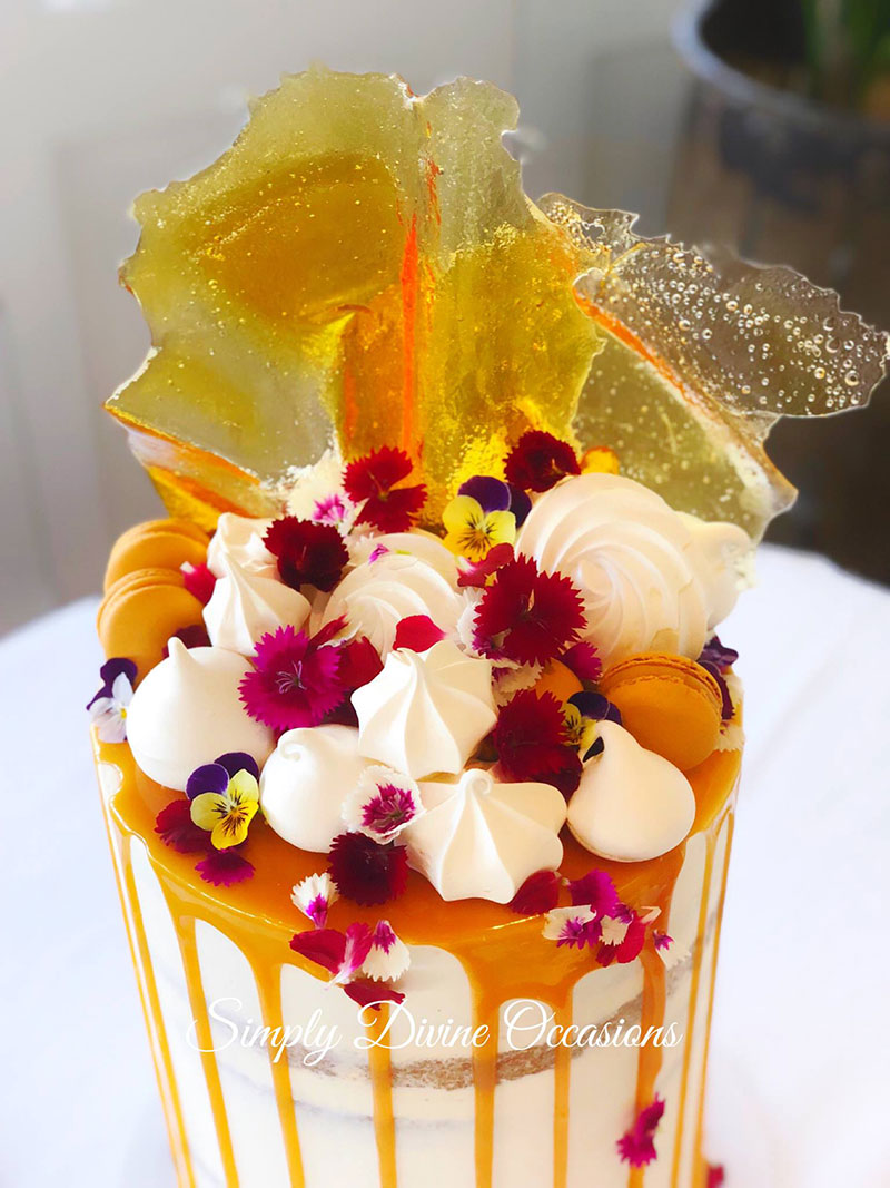 Wedding cake with toffee, meringues and edible flowers.