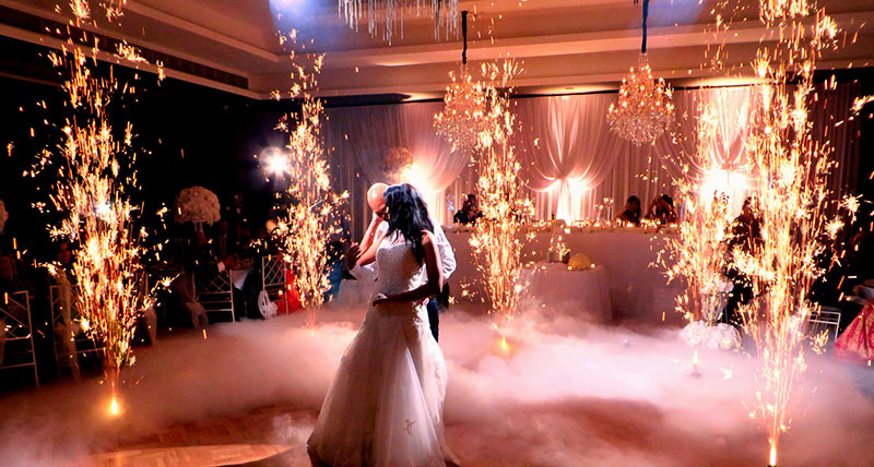 Bride and Groom dancing amongst fireworks fountains and dry ice effects.