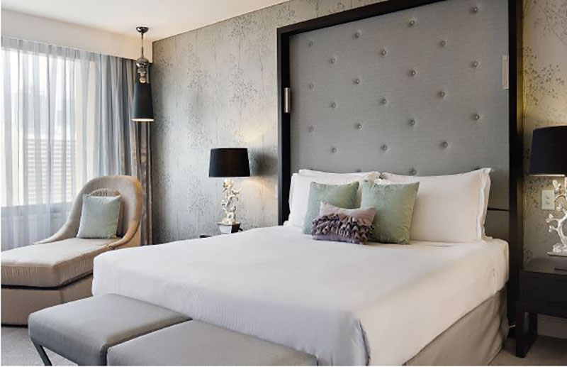 Luxurious Junior Suite in silver and mint hues at Sofitel Brisbane Central.